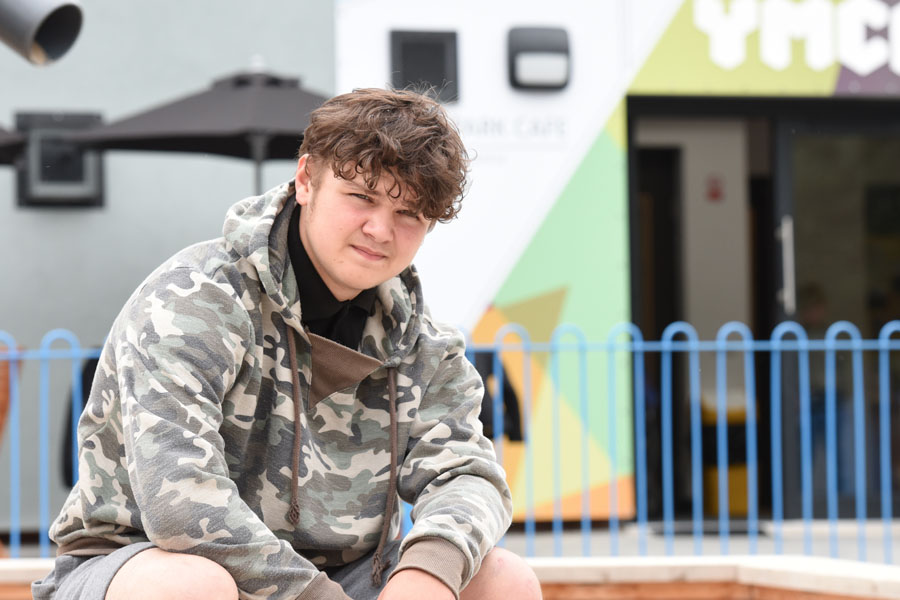 Young person sitting outside cafe